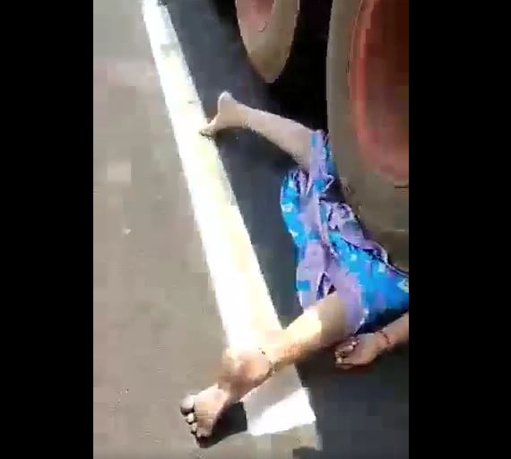 An Indian woman was pinned under the wheel of a truck