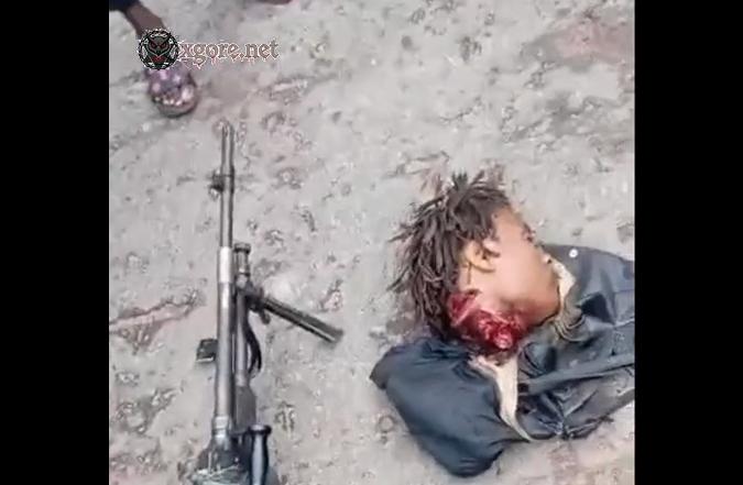 The armed self-defense group showed off a severed head
